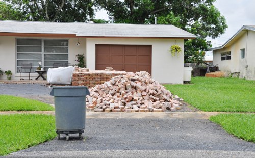 Workers securing skip load during collection for rubbish removal service
